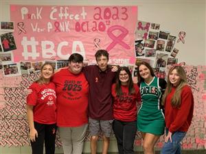student government representatives  pose in front of Pink Effect Collagepose in front of 